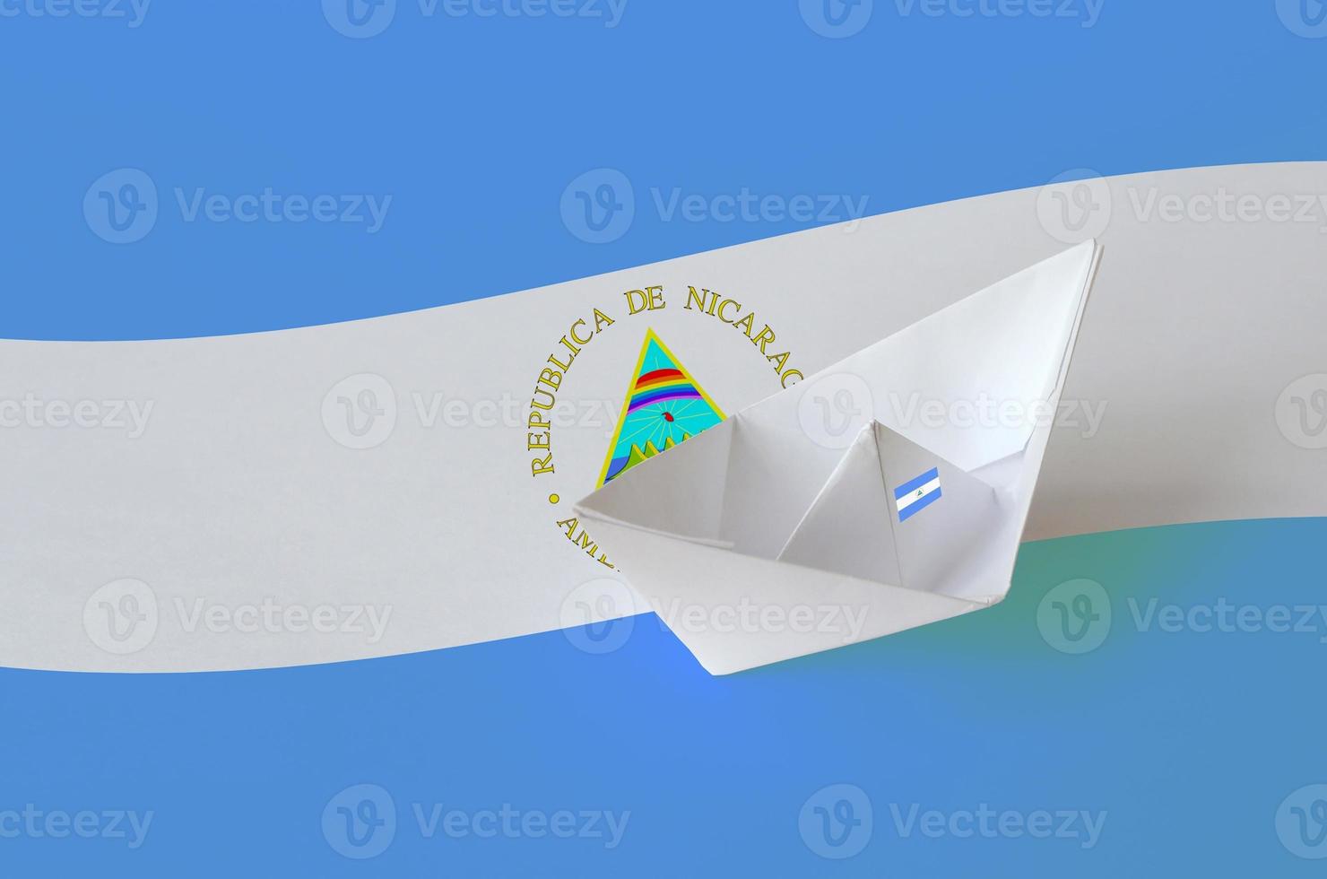 Nicaragua flag depicted on paper origami ship closeup. Handmade arts concept photo