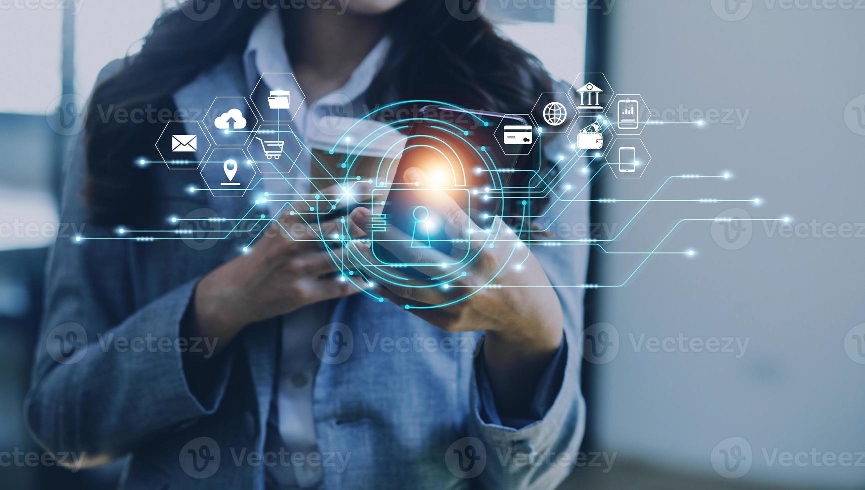 Cybersecurity and privacy concepts to protect data. Lock icon and internet network security technology. Businessman protecting personal data on smart phone with virtual screen interfaces. photo
