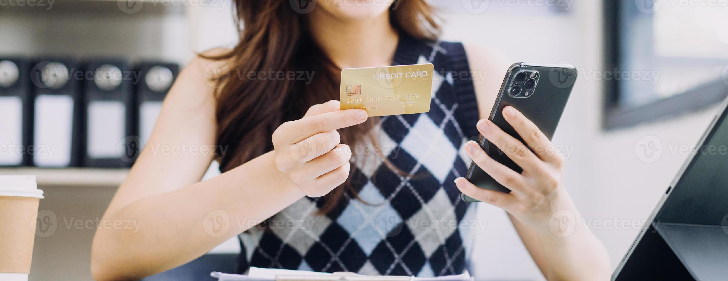 Woman hand using smart phone and laptop in outdoor nature park and sunset sky with bokeh light abstract background. Technology business and freelance working concept. Vintage tone filter color style. photo