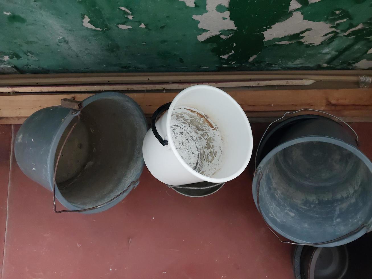 Plastic buckets lie on the balcony of the house photo