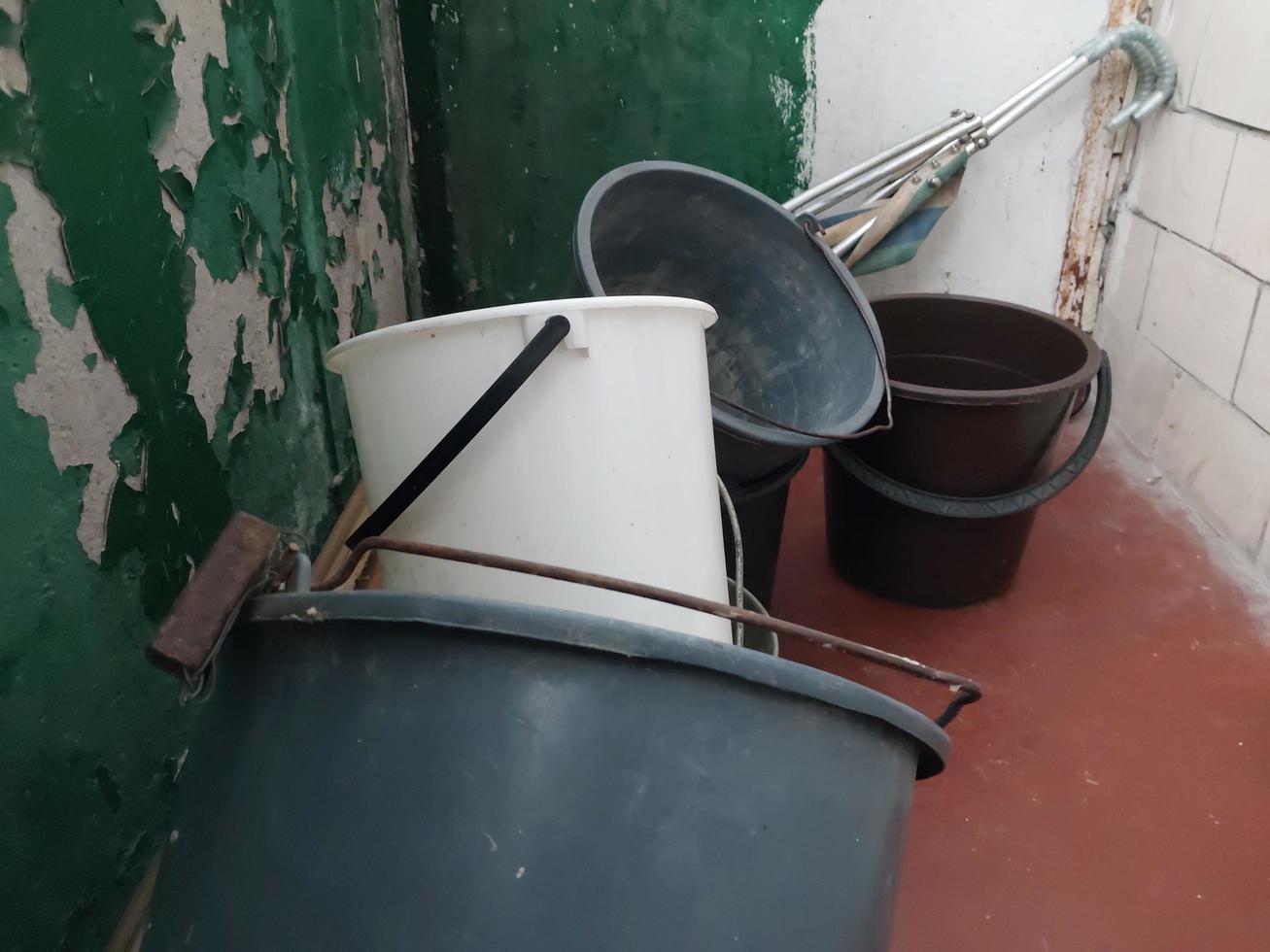 Plastic buckets lie on the balcony of the house photo