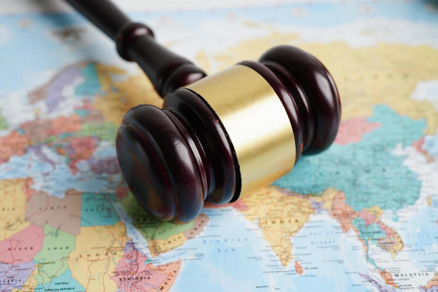 Bangkok, Thailand - May 15, 2022 Judges gavel on world map. photo