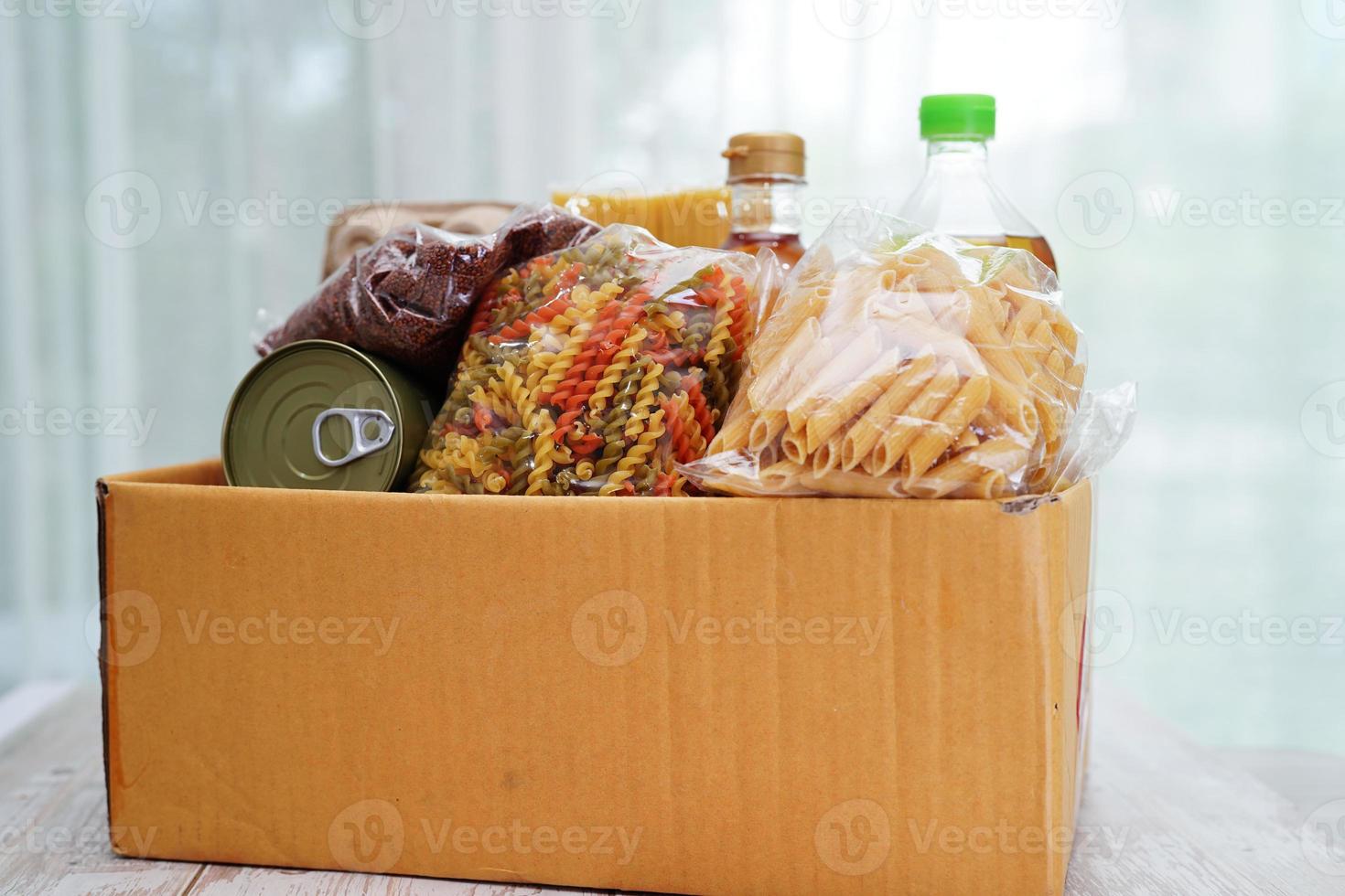 Foodstuffs in donation box for volunteer to help people. photo