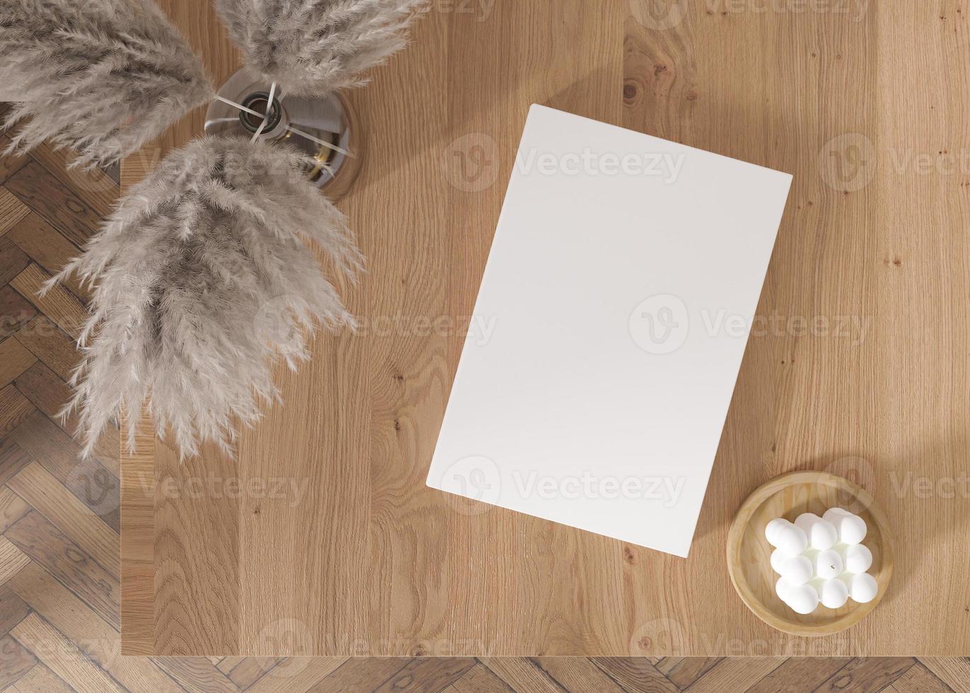 White book cover mock up with candle and vase with pampas grass on wooden table. Blank template for your design. Top view, close-up. Book, catalogue or magazin cover presentation. 3D rendering. photo