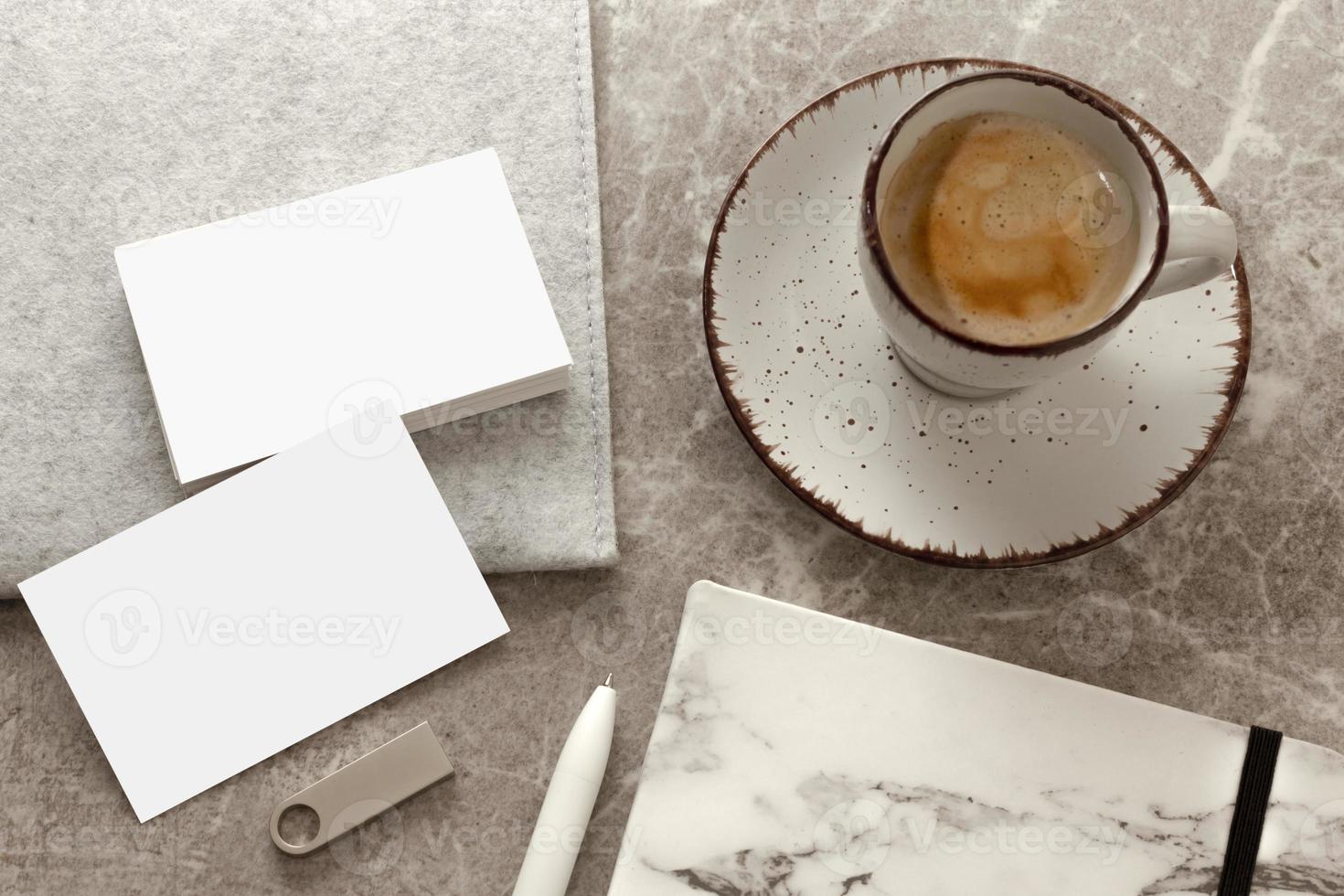 Blank white business cards on table, with blank USB stick, cup of coffee. Mockup for branding identity. Possibility to show both sides of card. Template for graphic designers. Free space, copy space. photo