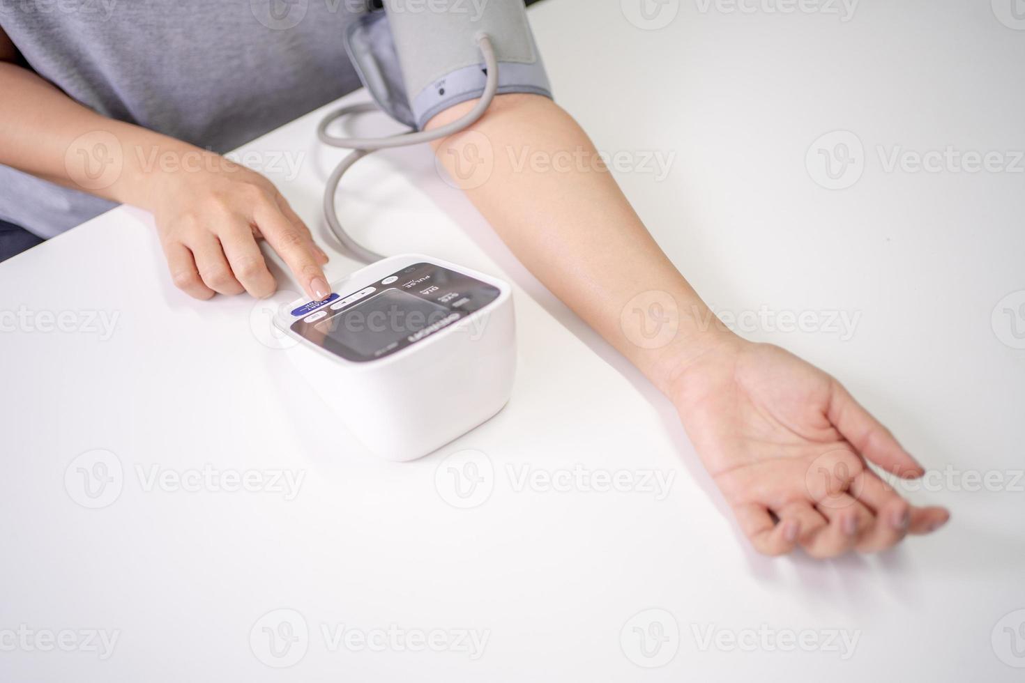 Self blood pressure and heart rate measurement with blood pressure monitor machine, with copy space photo