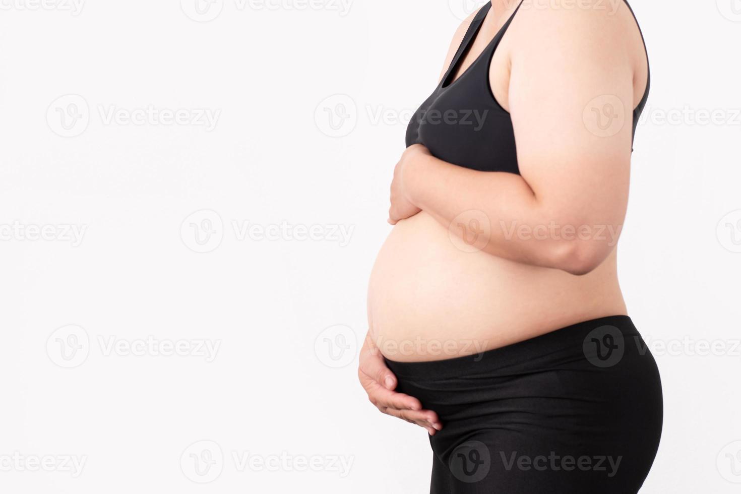 The side of the woman is pregnant and isolated white background. photo