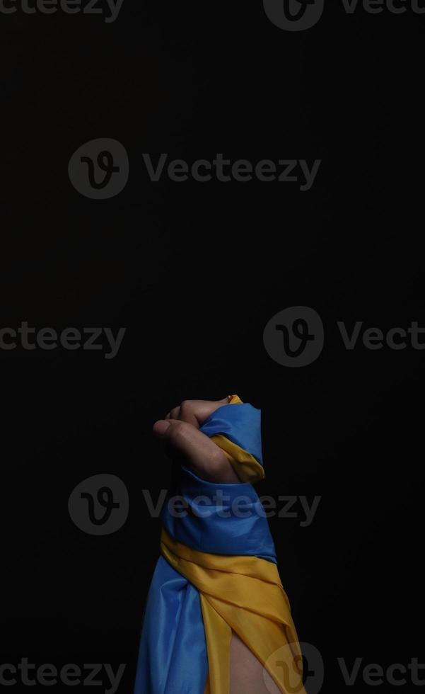 Russian flag and Ukraine flag in hands showing symbol of struggle war photo