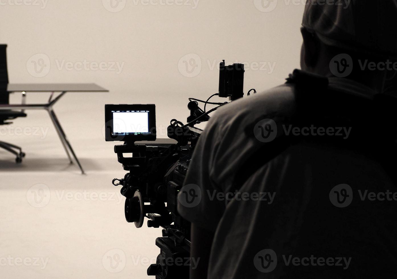 Behind the scenes or making of film in the studio and silhouette of camera man. photo