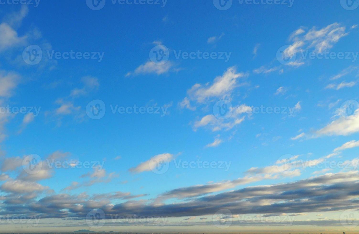 Clear blue sky and white clouds over the city and sunset. photo