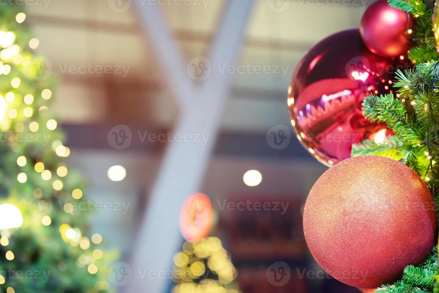 Closeup of bauble colorful variety hanging from a decorated christmas tree on blurred of lights with decorated tree, sparkling and bokeh background. copy space for your text. Christmas Tree Decoration photo