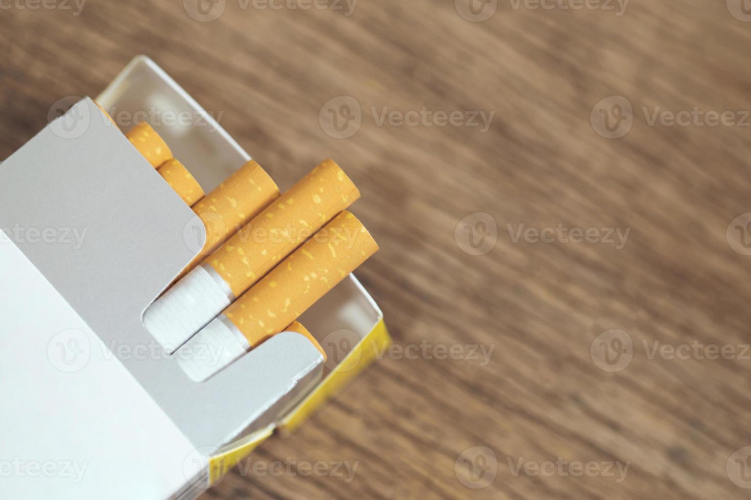 peel it off Cigarette pack prepare smoking. Packing line up put on the wooden table. photo filters Natural light.