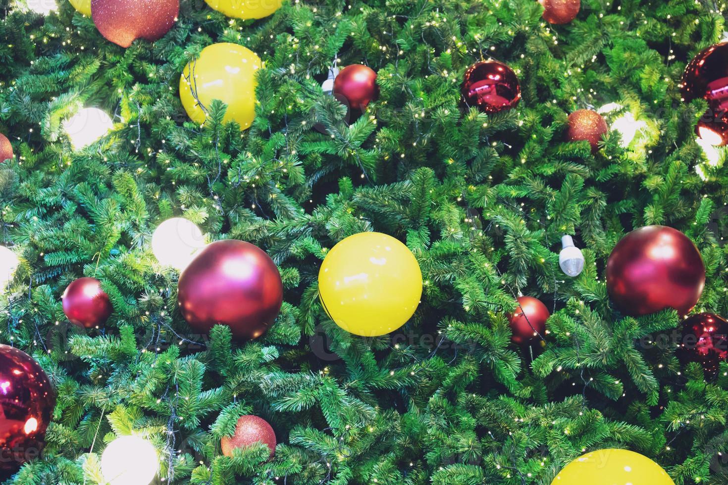 Closeup of bauble colorful variety hanging from a decorated christmas tree on blurred of lights with decorated tree, sparkling and bokeh background. copy space for your text. Christmas Tree Decoration photo