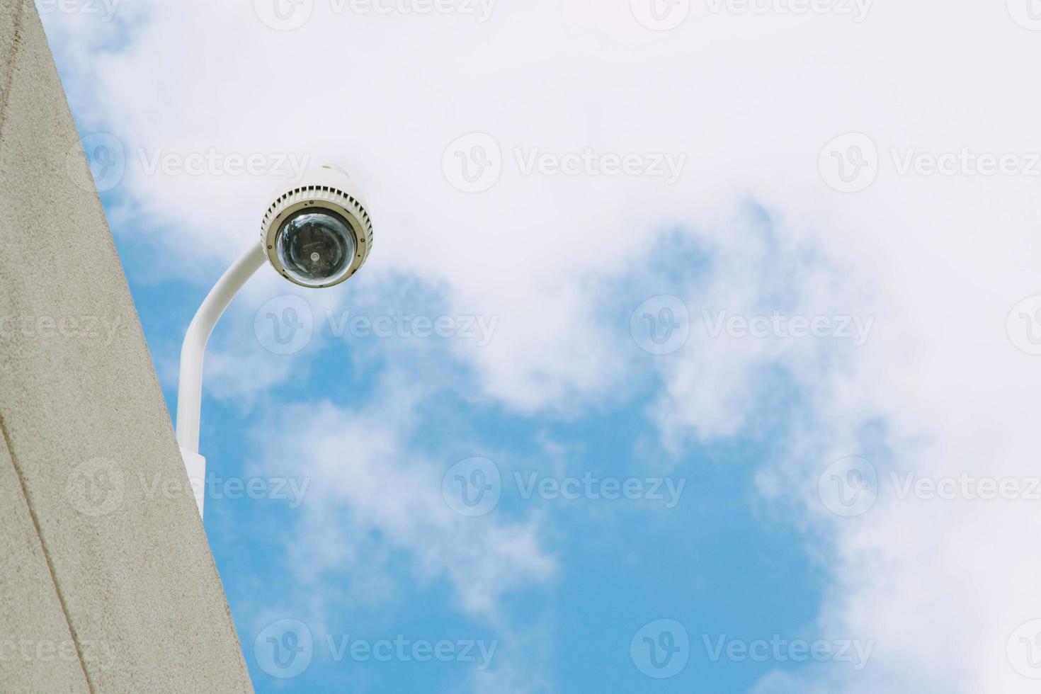 Security CCTV camera office building for monitor events, top view background sky. photo