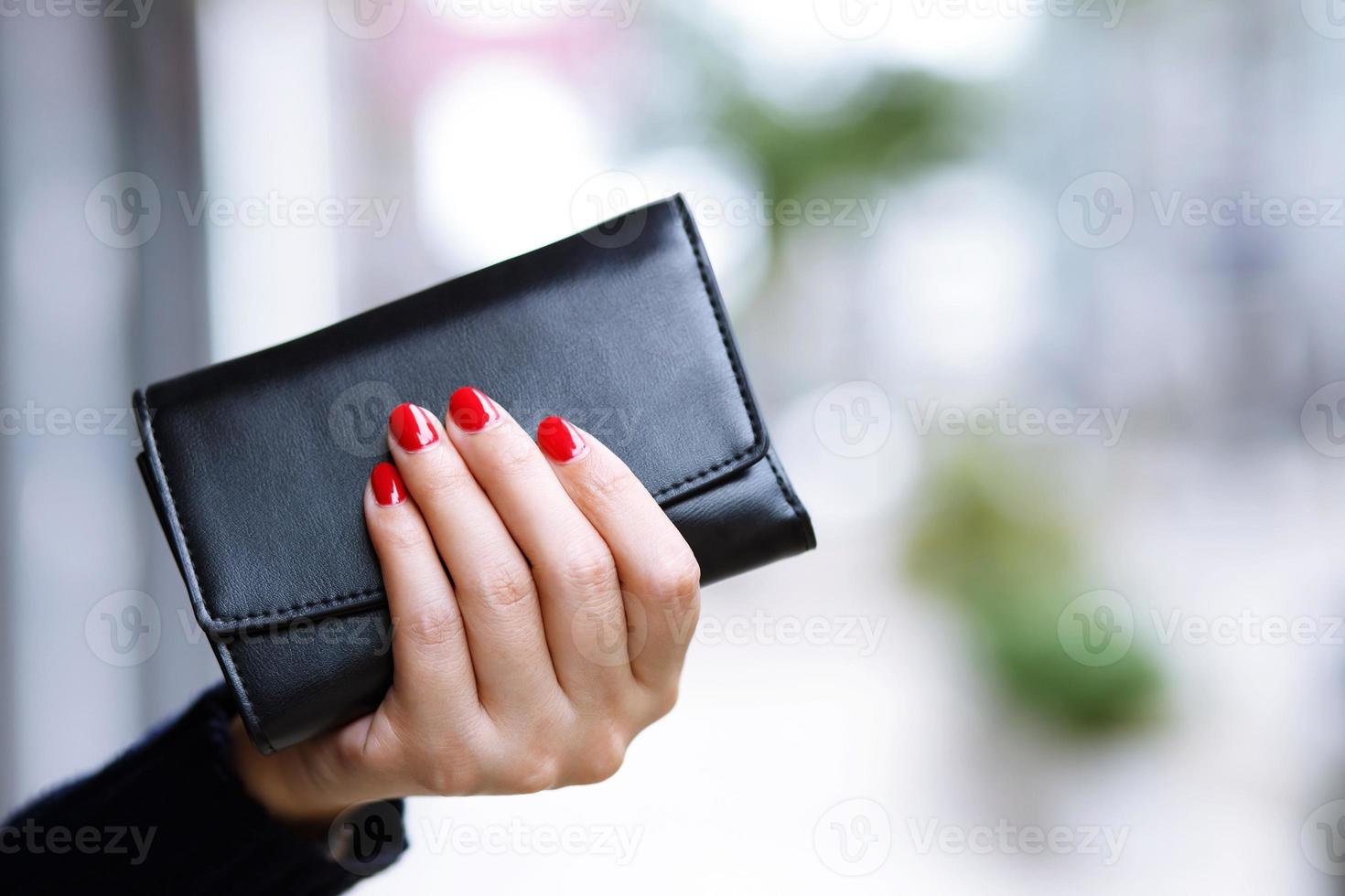 Woman holding a purse, ready, shopping, goods, at the mall photo