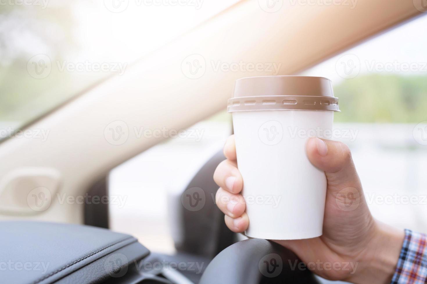 business man drinking beverage paper cup coffee of hot in hand while standing car on the side before driving a vehicle in the morning sunlight. transportation and vehicle concept. photo