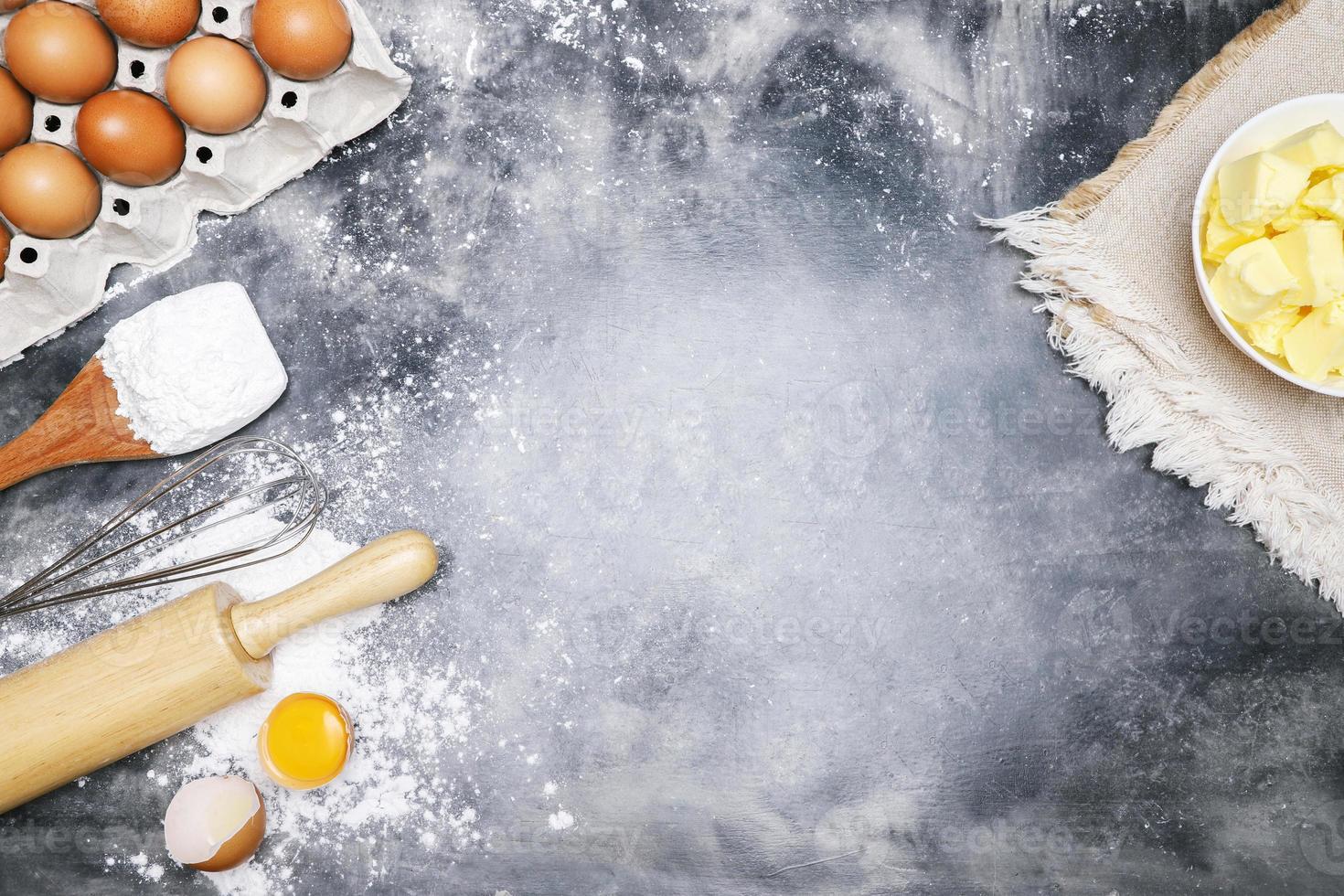 dough preparation recipe bread. Baking ingredients bakery cooking. butter on sackcloth, egg and flour on black board. flat lay on table Bare mortar cement style loft background. Top view, copy space. photo