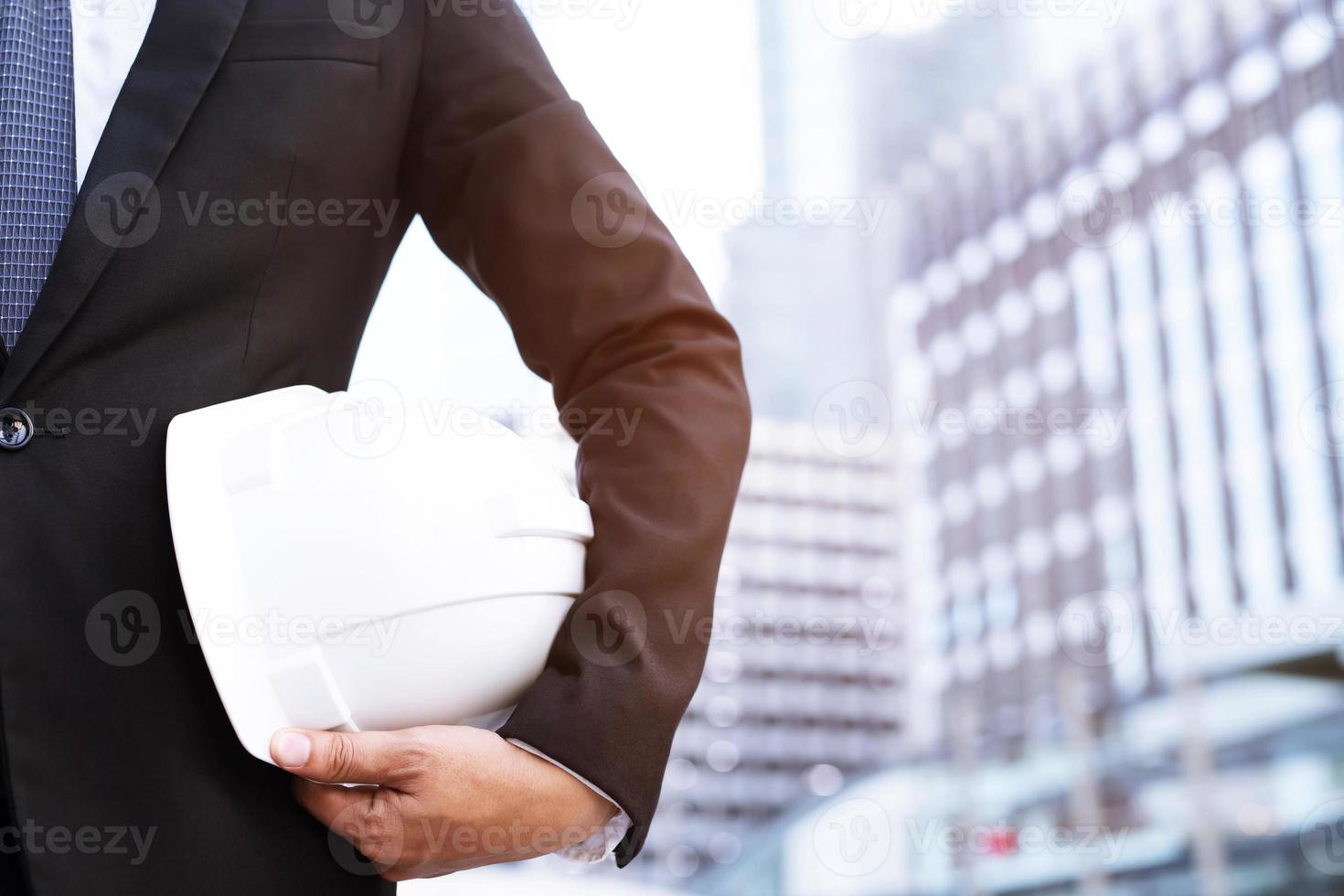 Close up engineers working on a building site holding a blueprints photo