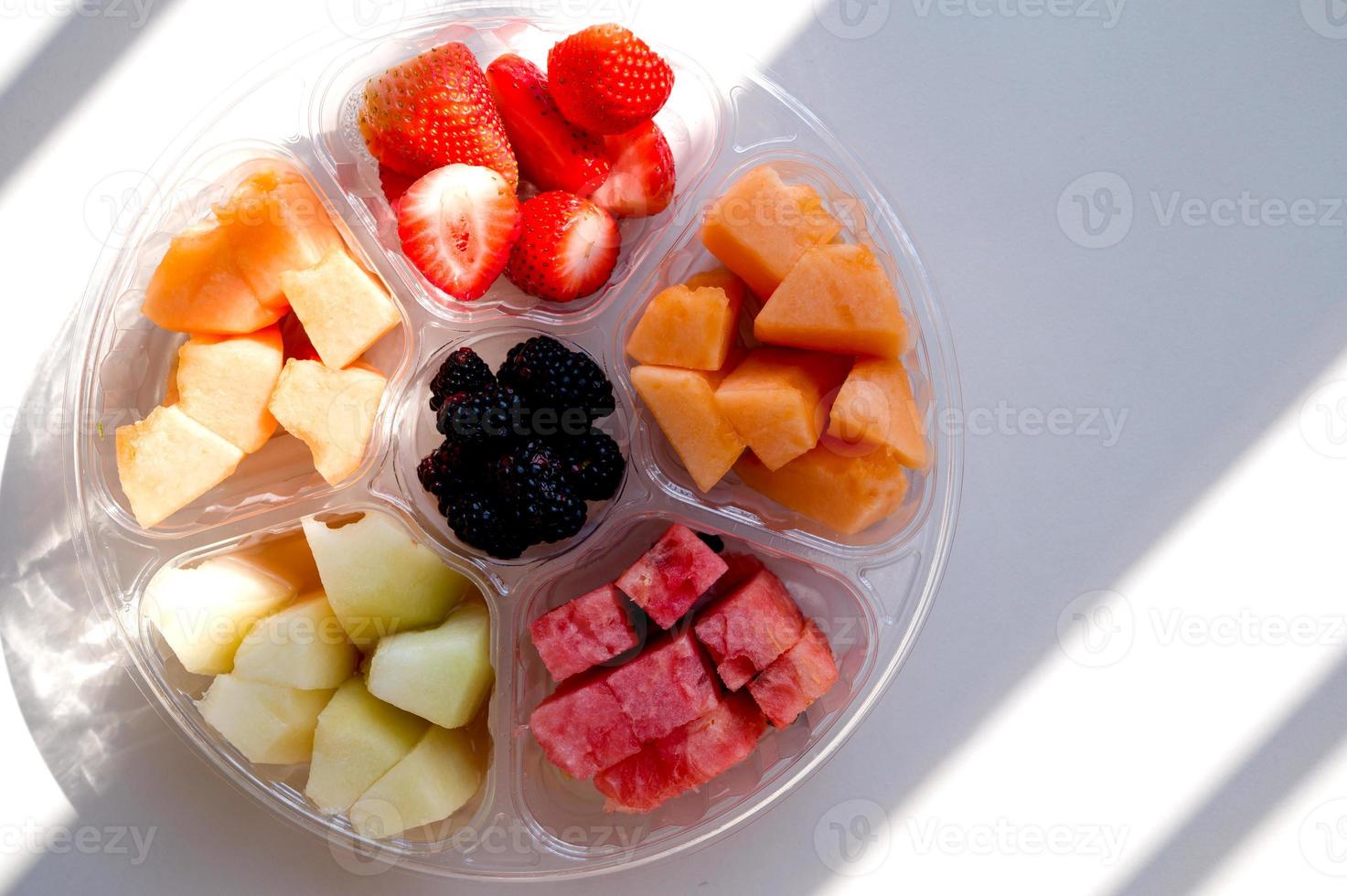 Top view on a mixed plate woth fruit and berries.Vegan,vegetarian.Copyspace banner photo