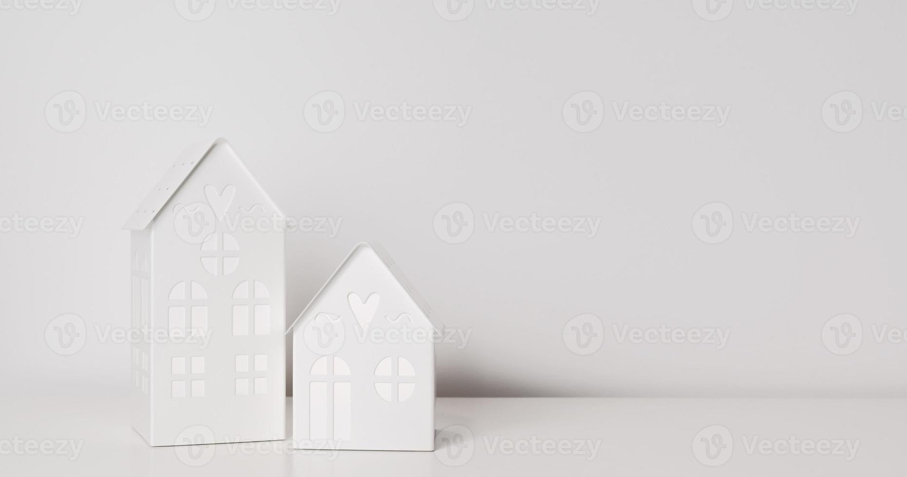 Minimalistic winter holidays background with deocational houses with lights. New year or christmas concept photo