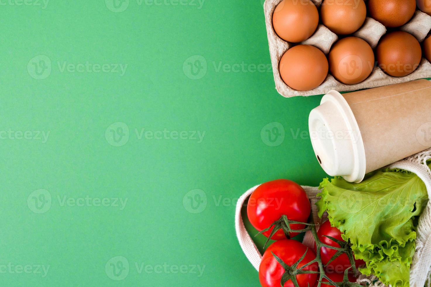 Zero waste concept. Food in eco containers and bag against green background.Flat lay photo
