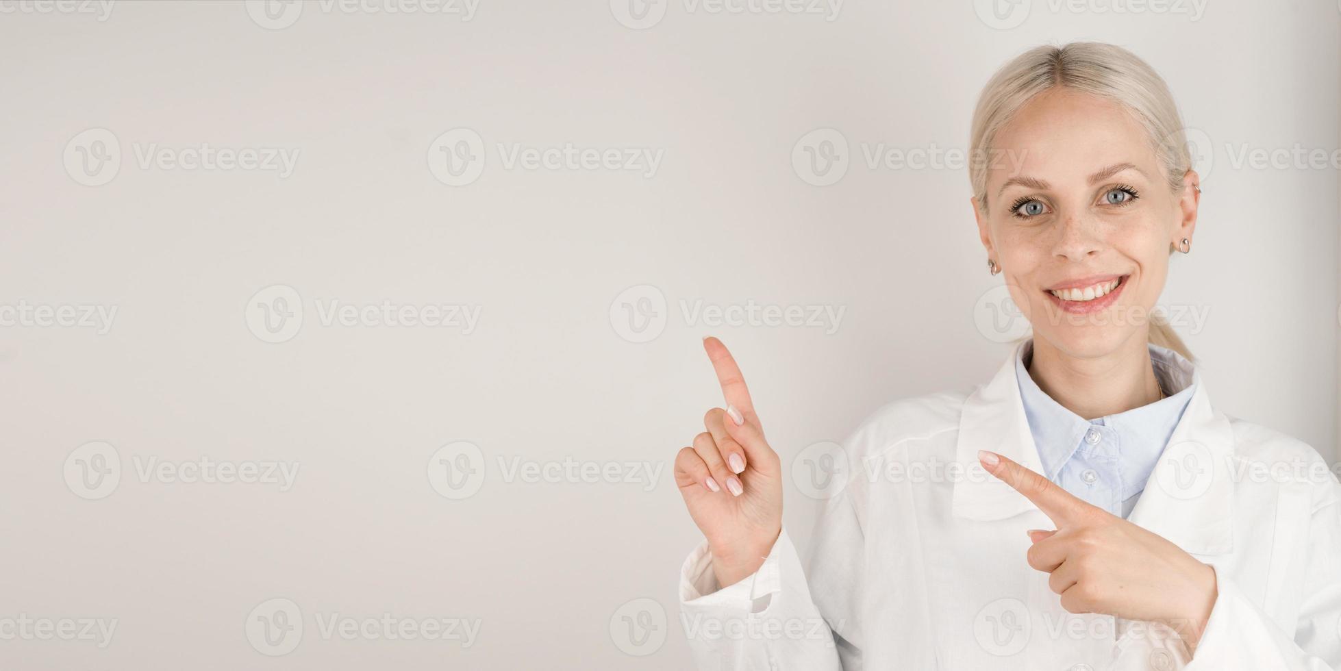 Medical banner with place for text.Happy doctor pointing at empty space photo