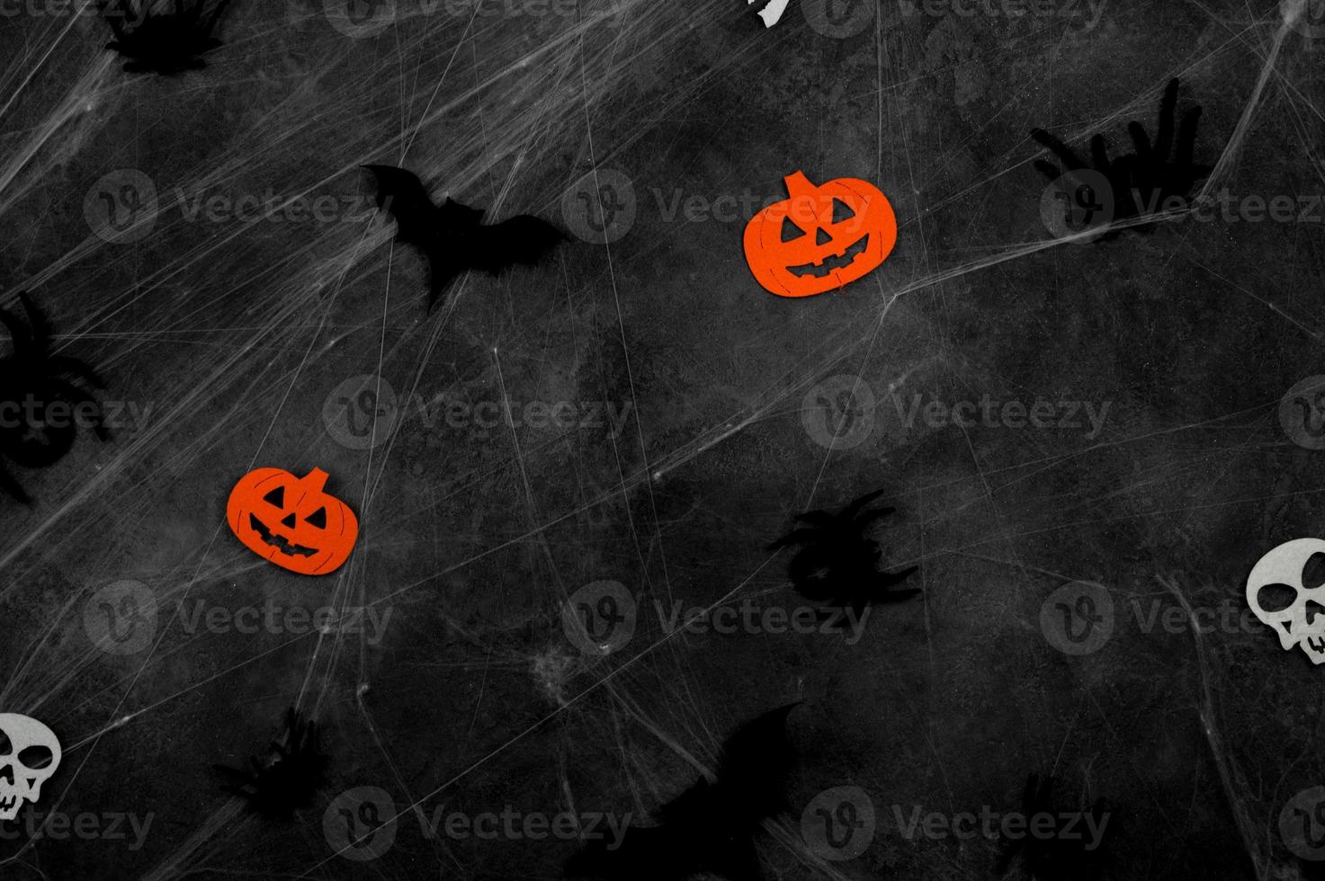 Top view on dark halloween background with bats,spiders,skulls and spider web. photo