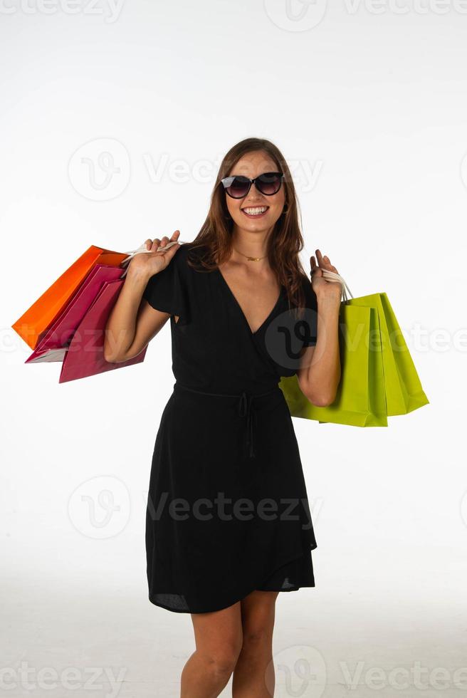 Young beautiful woman holding shopping bag on isolated white background photo