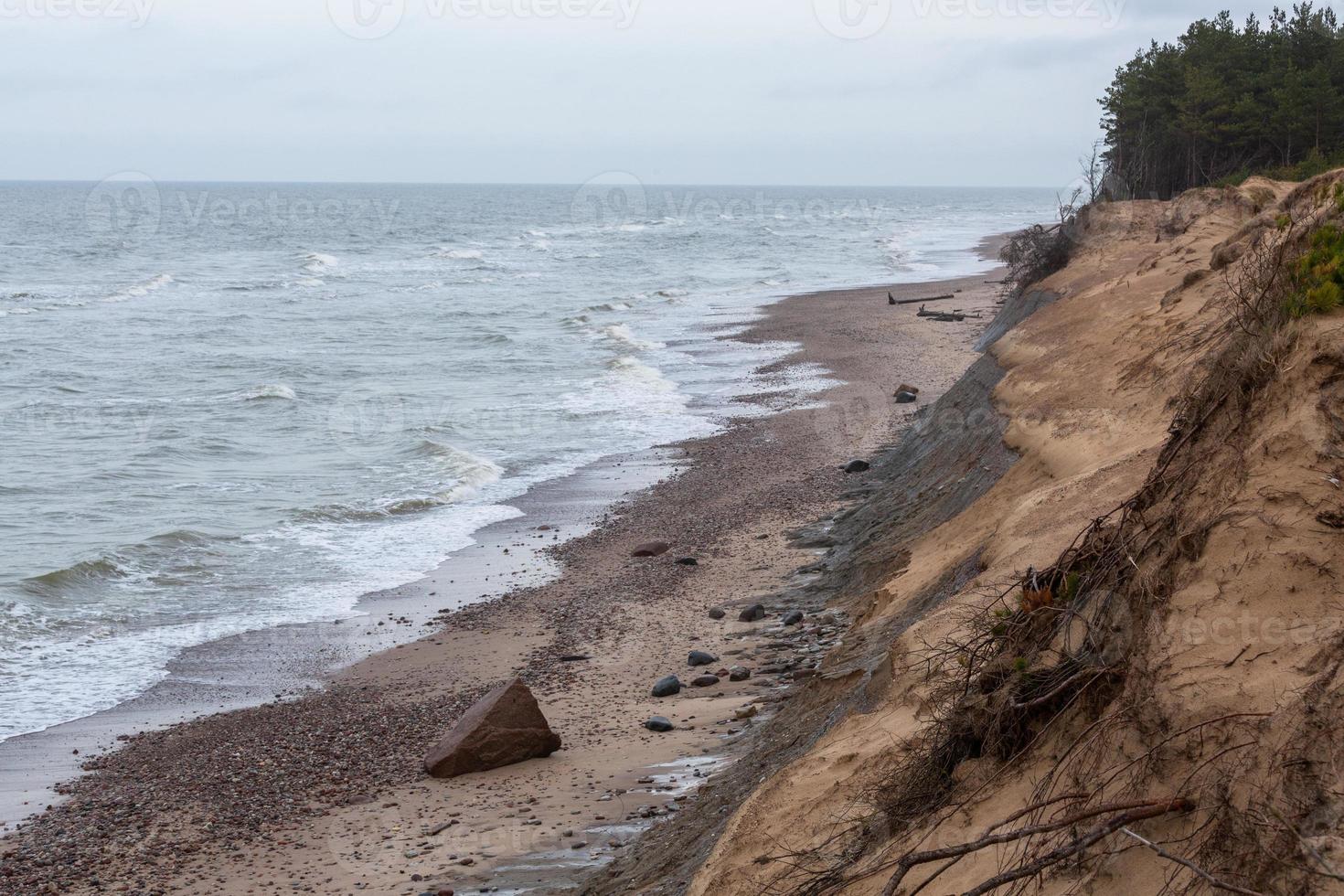 Baltic Sea Coast With Pebbles And Ice at Sunset photo