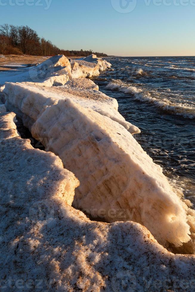 Baltic Sea Coast With Pebbles And Ice at Sunset photo