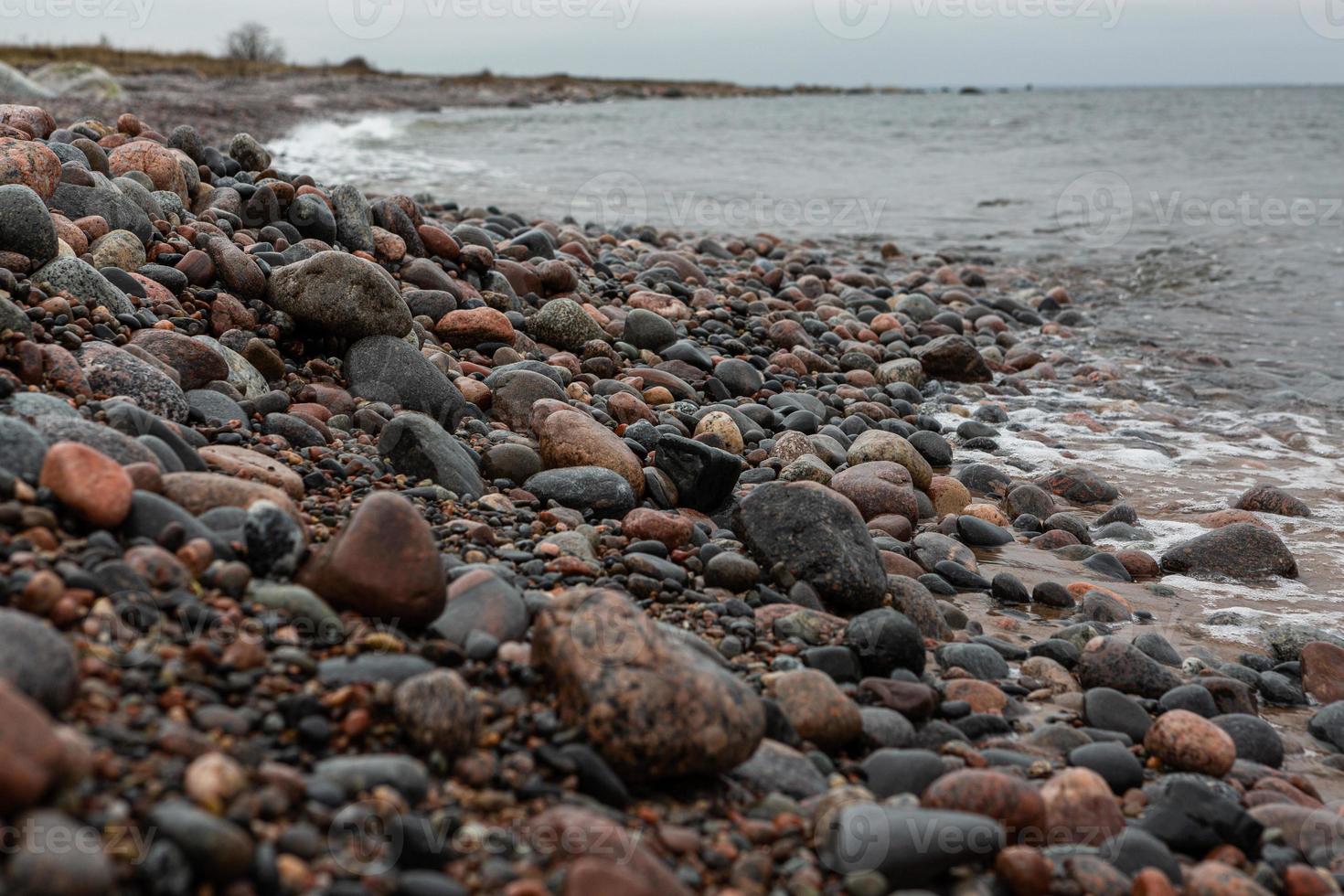 Baltic Sea Coast With Pebbles And Ice at Sunset photo