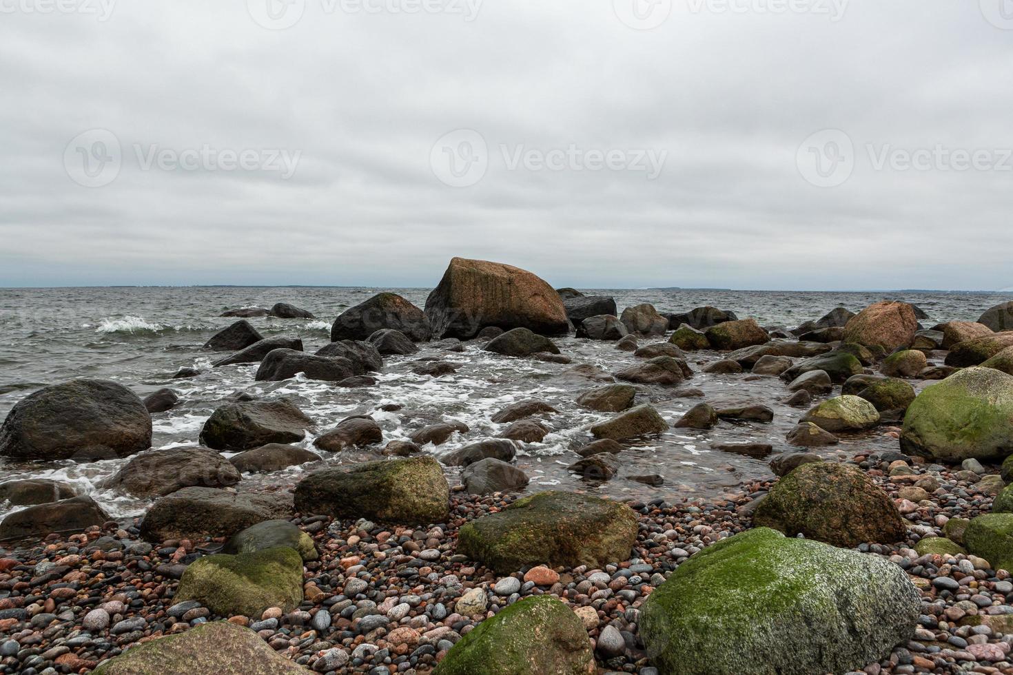 Baltic Sea Coast With Pebbles And Ice at Sunset photo