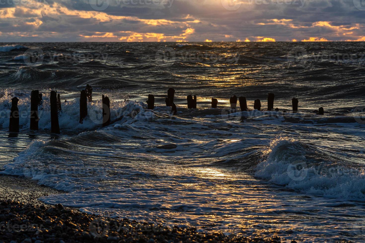 Baltic Sea Coast With Pebbles And Ice at Sunset photo