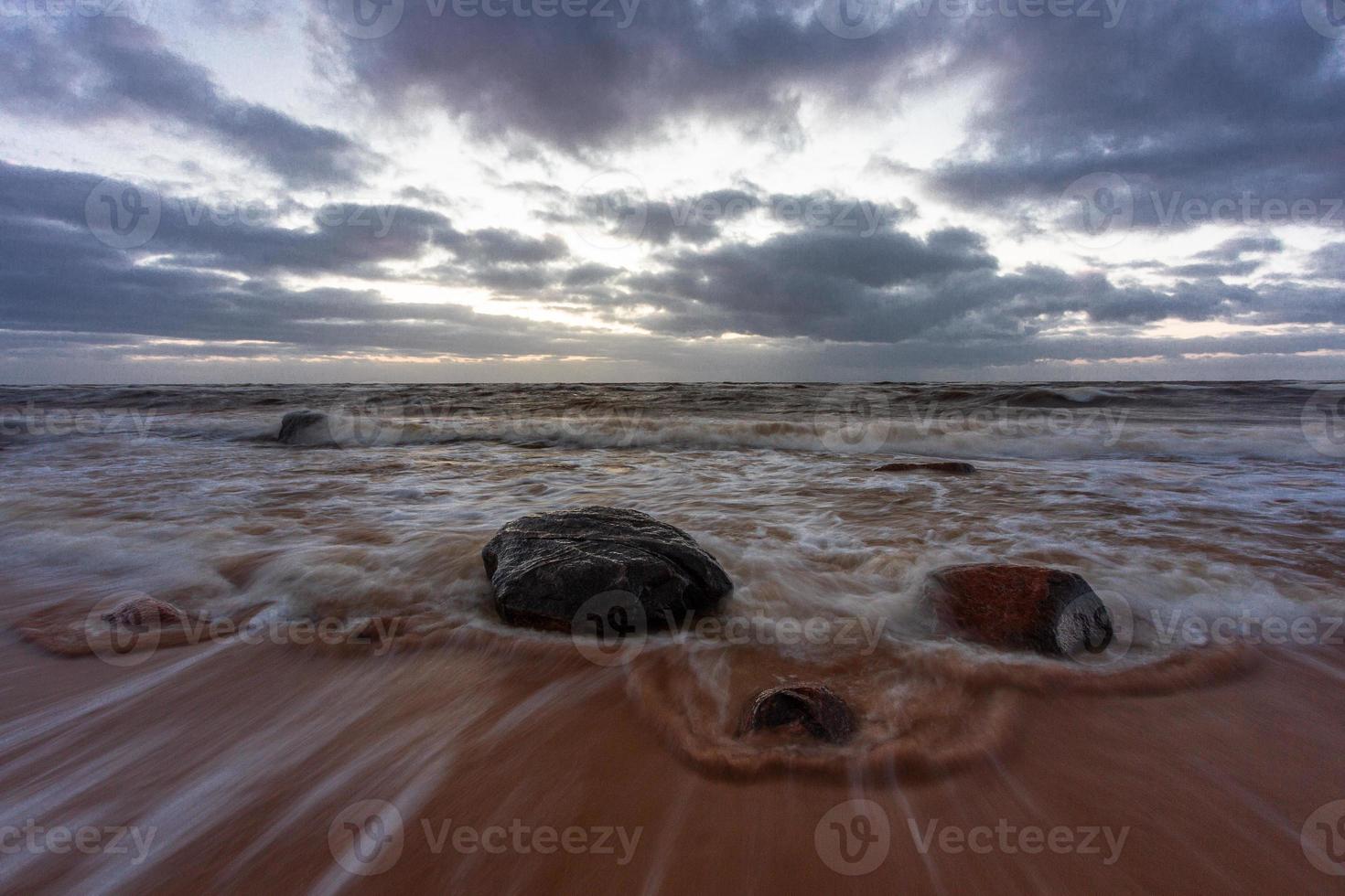 Baltic Sea Coast With Pebbles And Ice at Sunset photo