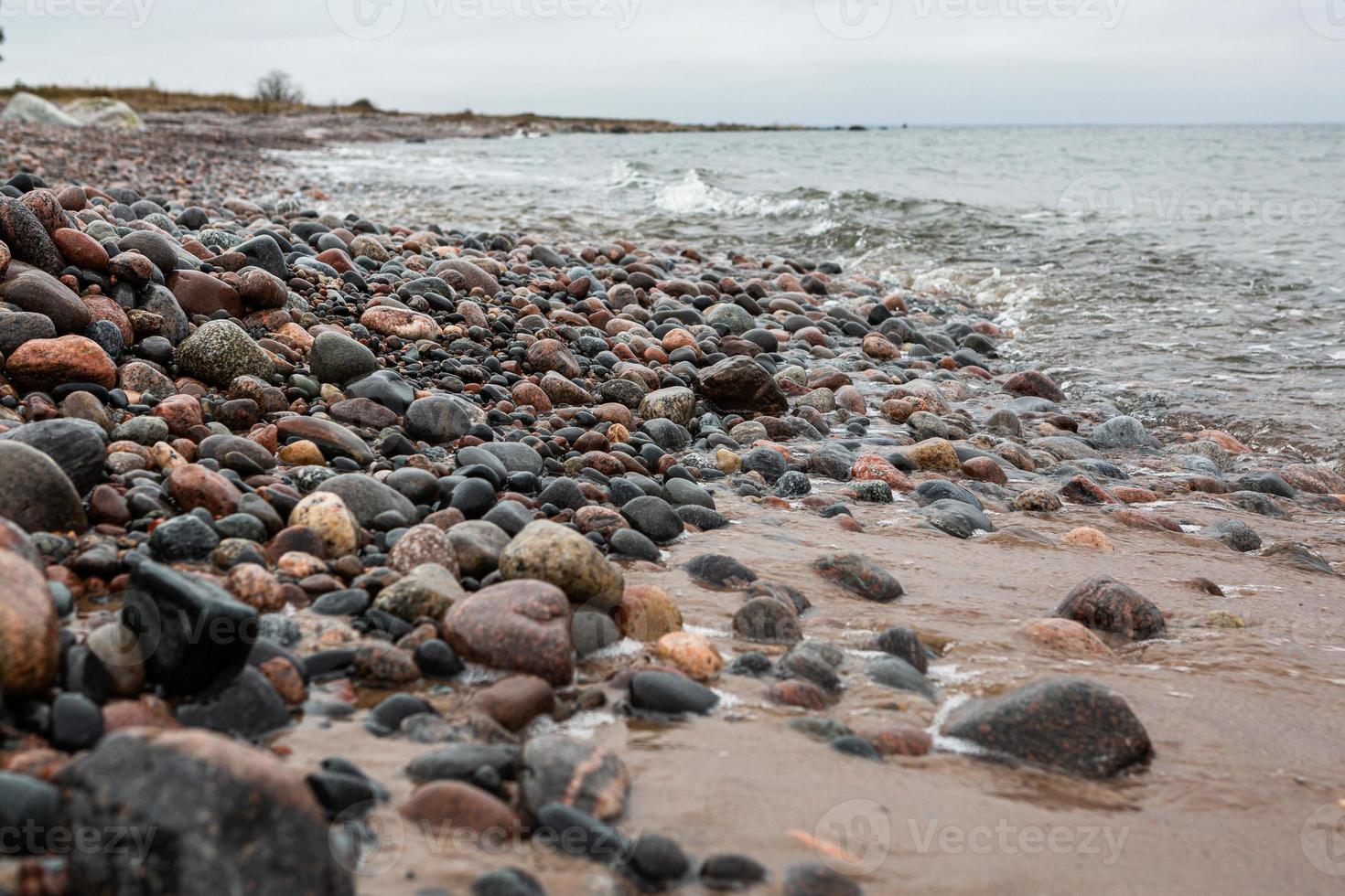 Baltic Sea Coast With Pebbles And Ice at Sunset photo