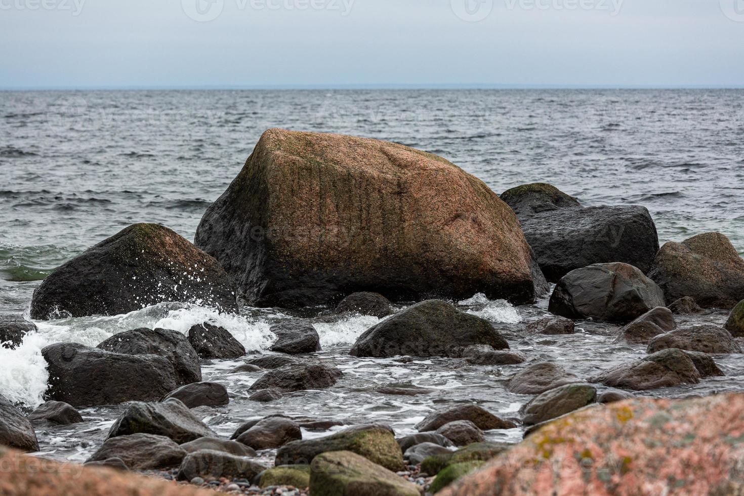 Baltic Sea Coast With Pebbles And Ice at Sunset photo