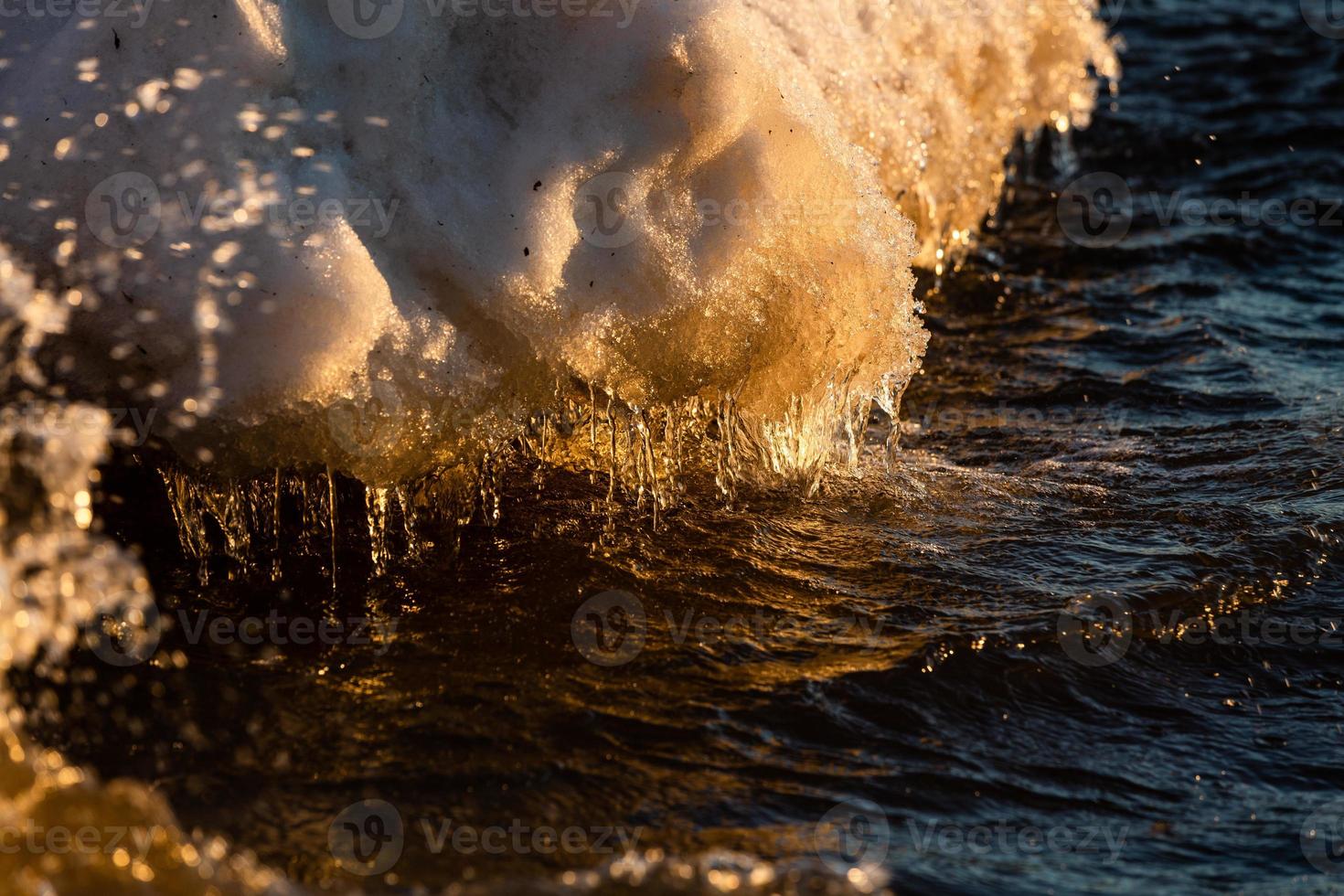 Baltic Sea Coast With Pebbles And Ice at Sunset photo