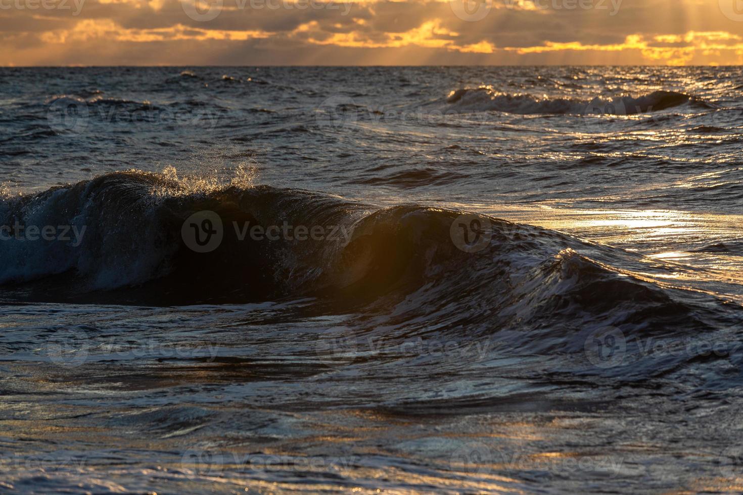 Baltic Sea Coast With Pebbles And Ice at Sunset photo