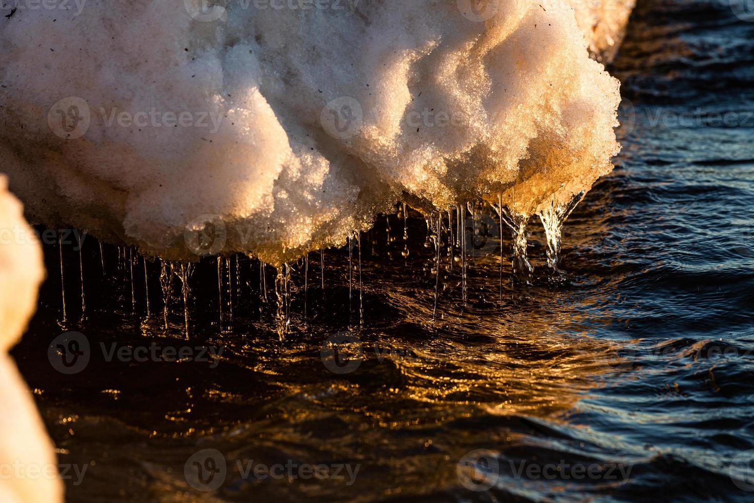 Baltic Sea Coast With Pebbles And Ice at Sunset photo