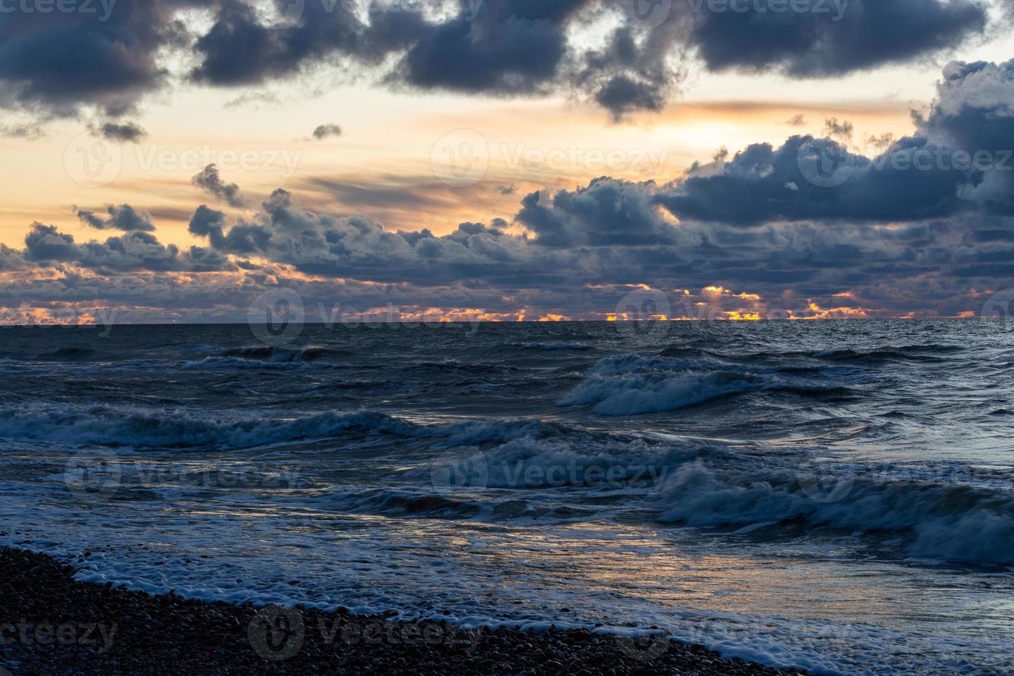 Baltic Sea Coast With Pebbles And Ice at Sunset photo