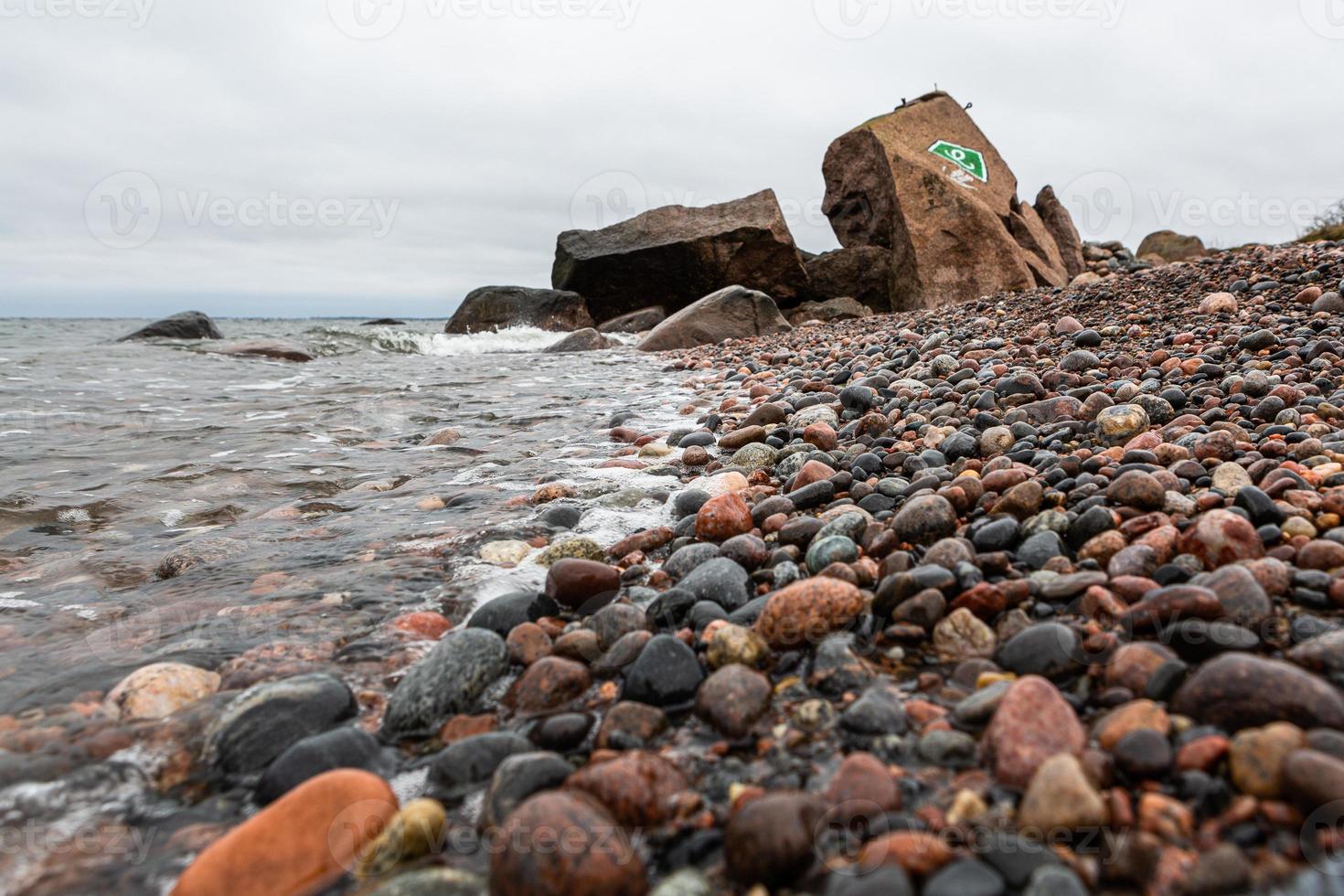 Baltic Sea Coast With Pebbles And Ice at Sunset photo