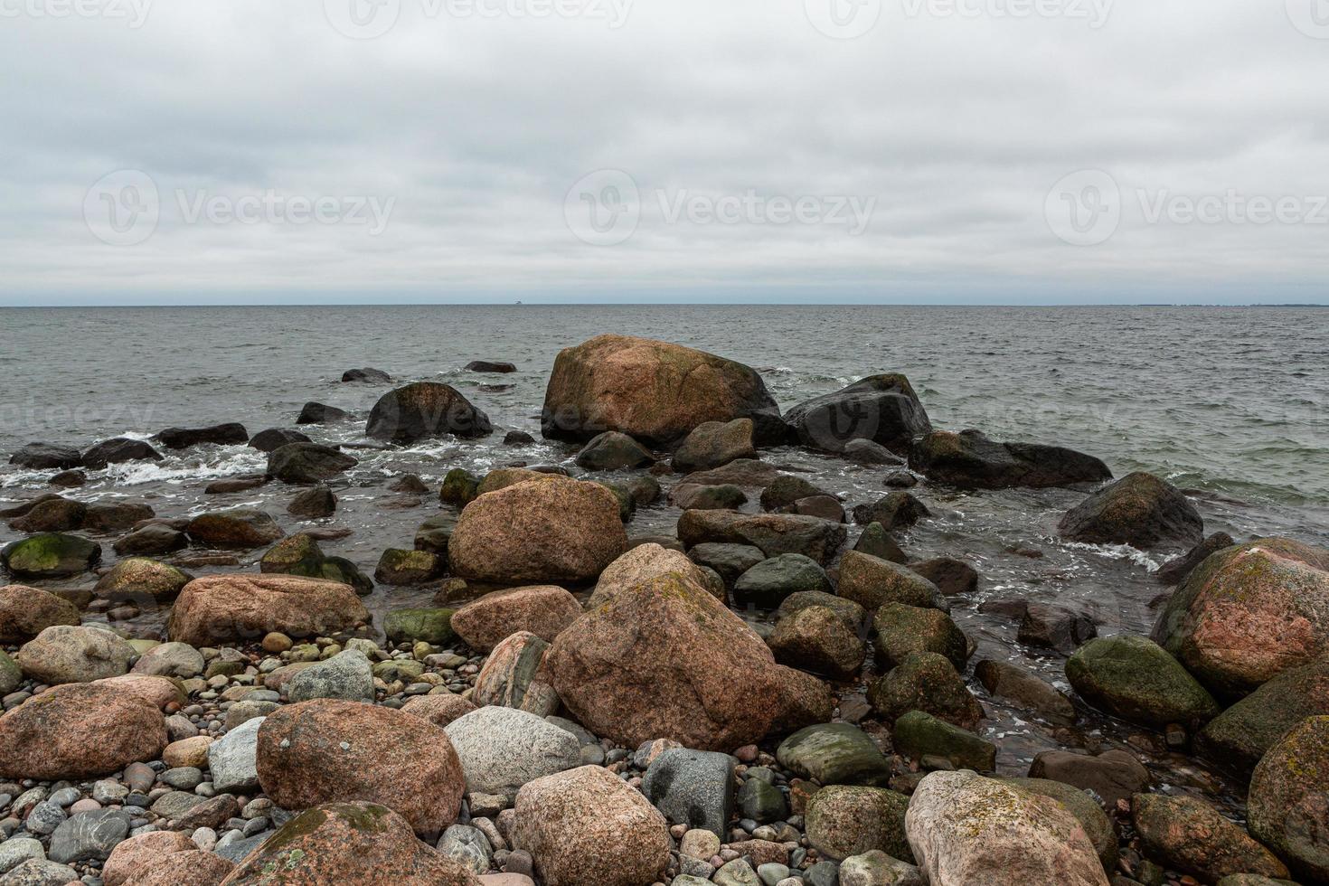 Baltic Sea Coast With Pebbles And Ice at Sunset photo