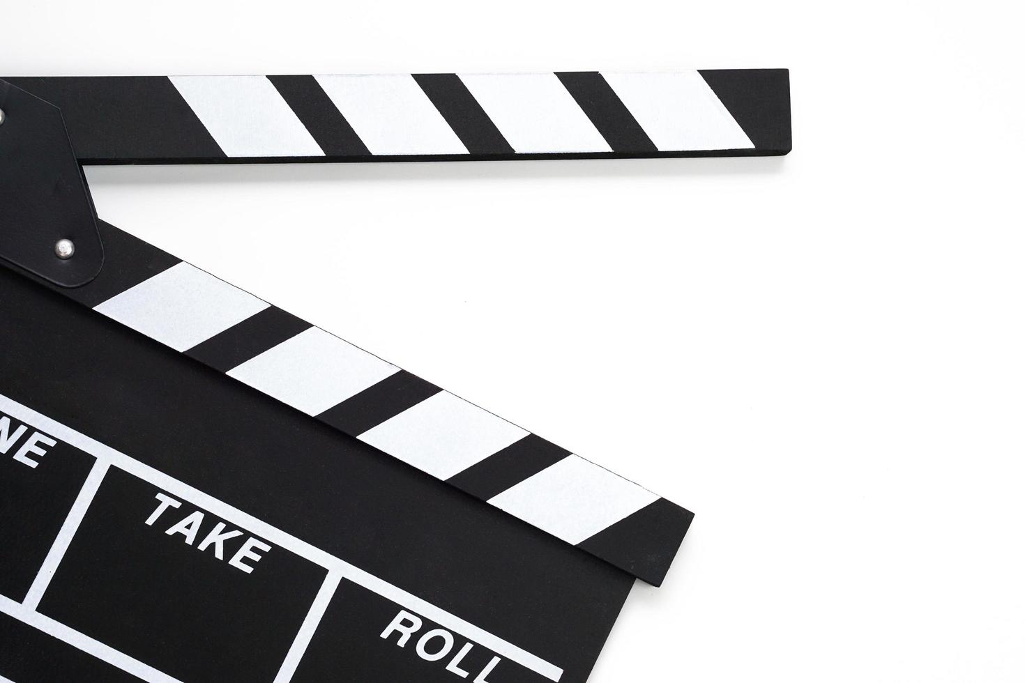 Clapperboard or movie slate black color on white background. Cinema industry, video production and film concept. photo