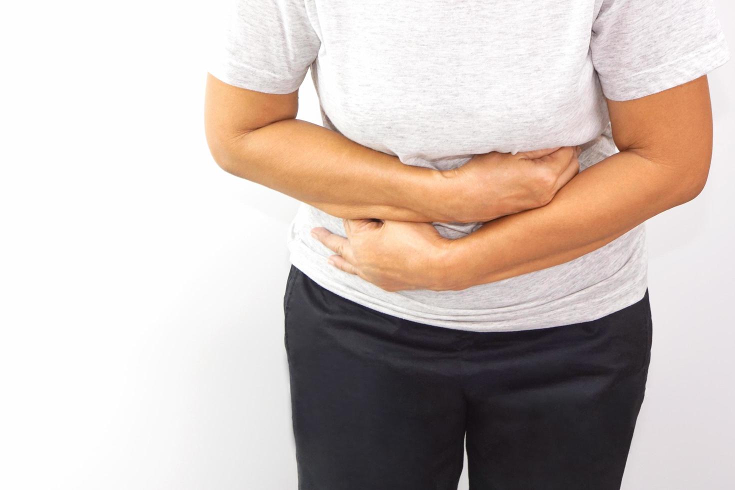 Asian woman suffering from stomachache. Chronic gastritis, menstruation and health concept. photo