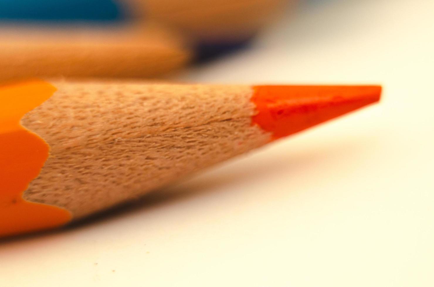 orange pencil close-up on a light background. minimalism photo