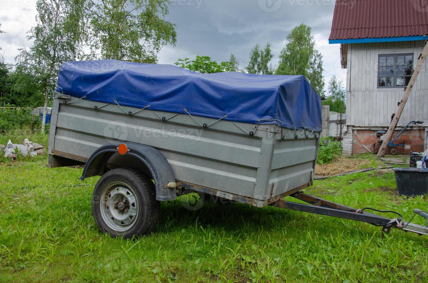 the trailer for the car is closed with an awning. Transportation of things. photo