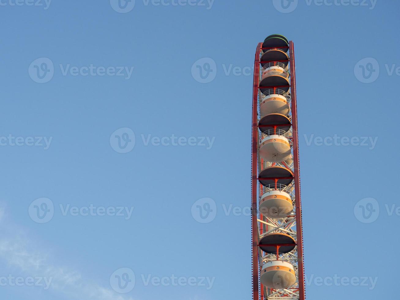 Ferris wheel against the sky. Amusement park on the sea. Rest zone. photo