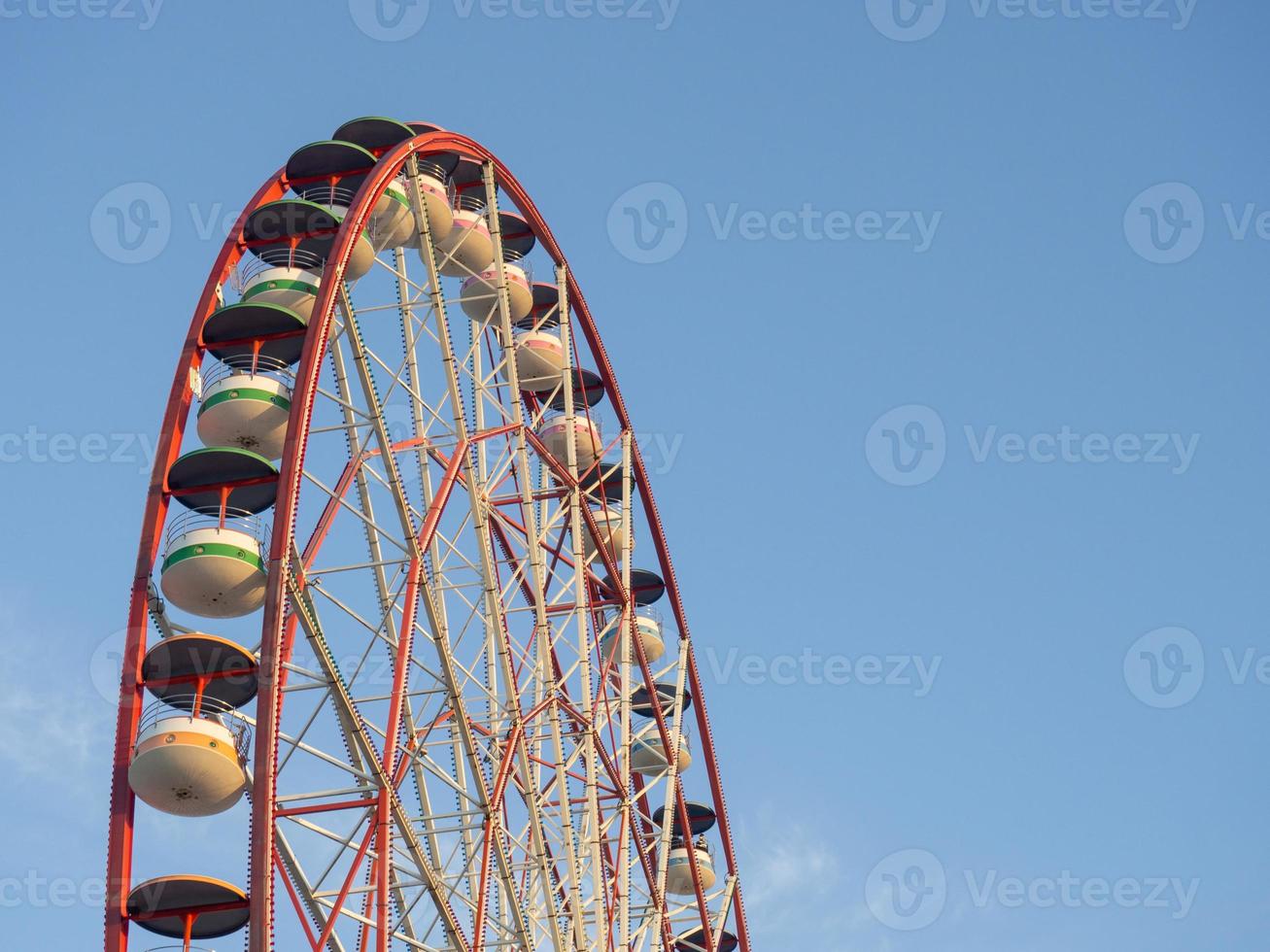 Ferris wheel against the sky. Amusement park on the sea. Rest zone. photo