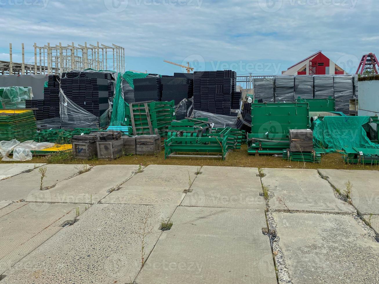 A large outdoor warehouse at a construction site, a warehouse for industrial equipment and materials in boxes at an open-air storage site photo