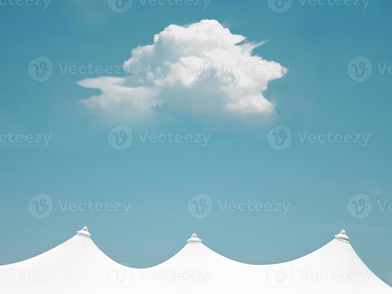 A single cloud above white roof structures photo